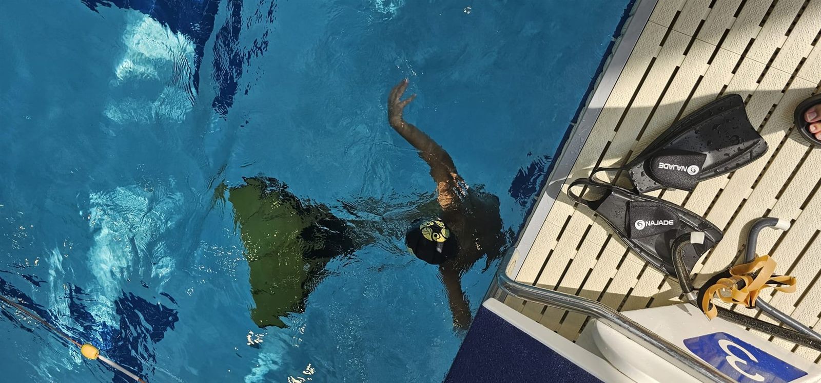 Young finswimmer with a monofin in the pool